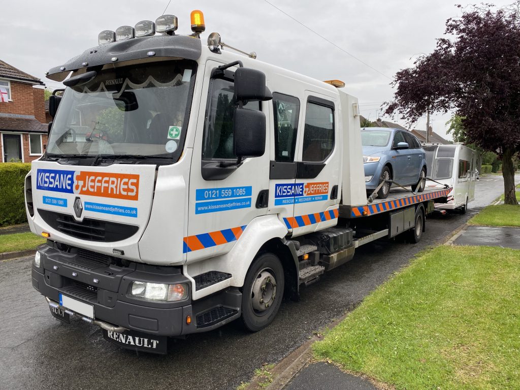 Recovery truck with a car towing a caravan